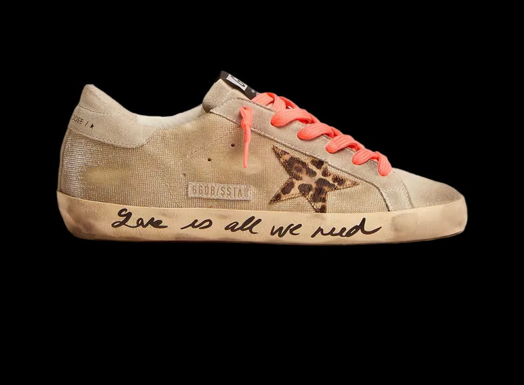 Gold-colored Super-Star sneakers with checkered pattern and handwriting
